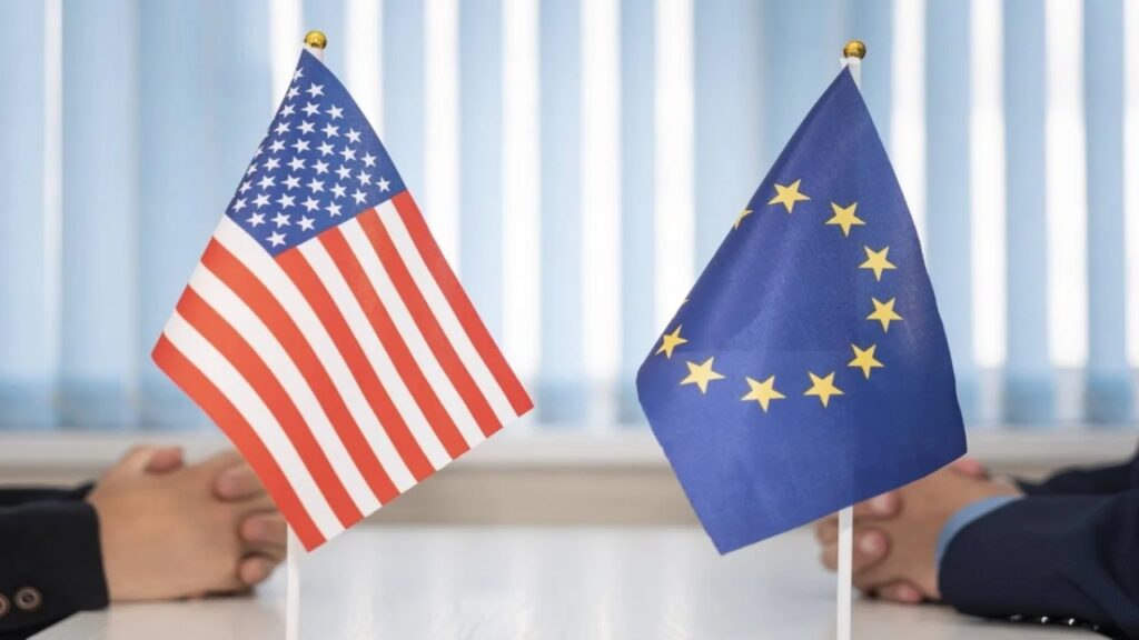 EU and US flags displayed during a high-level trade negotiation meeting symbolizing transatlantic economic relations.