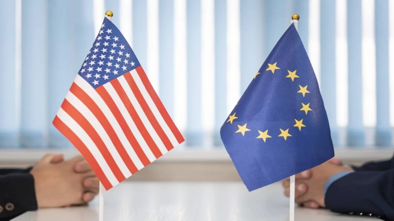 EU and US flags displayed during a high-level trade negotiation meeting symbolizing transatlantic economic relations.